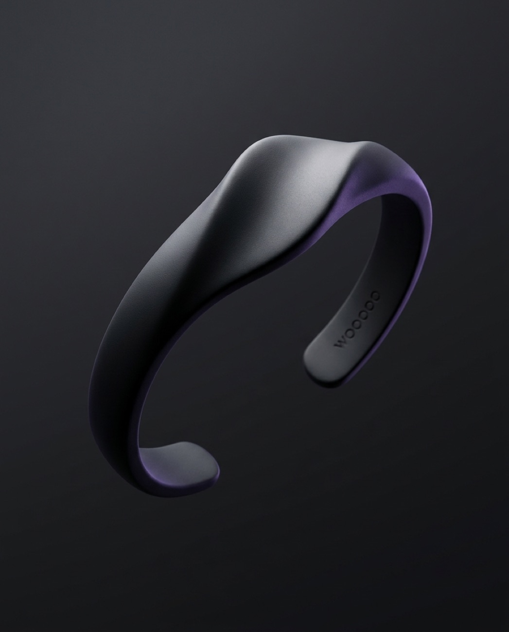 The WOOOOO bracelet in Obsidian, an open cuff with a single wave crest
